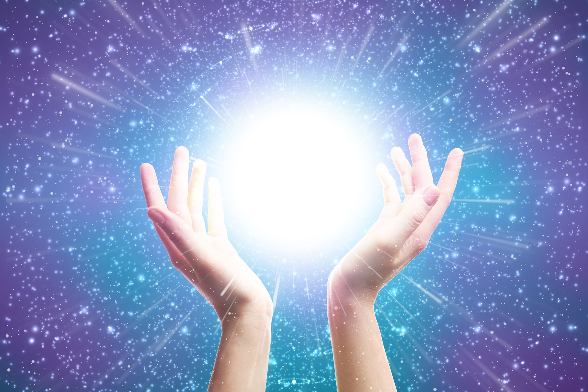 Hands Reaching Toward Glowing Light in Sparkling Galaxy Background Representing Energy and Healing